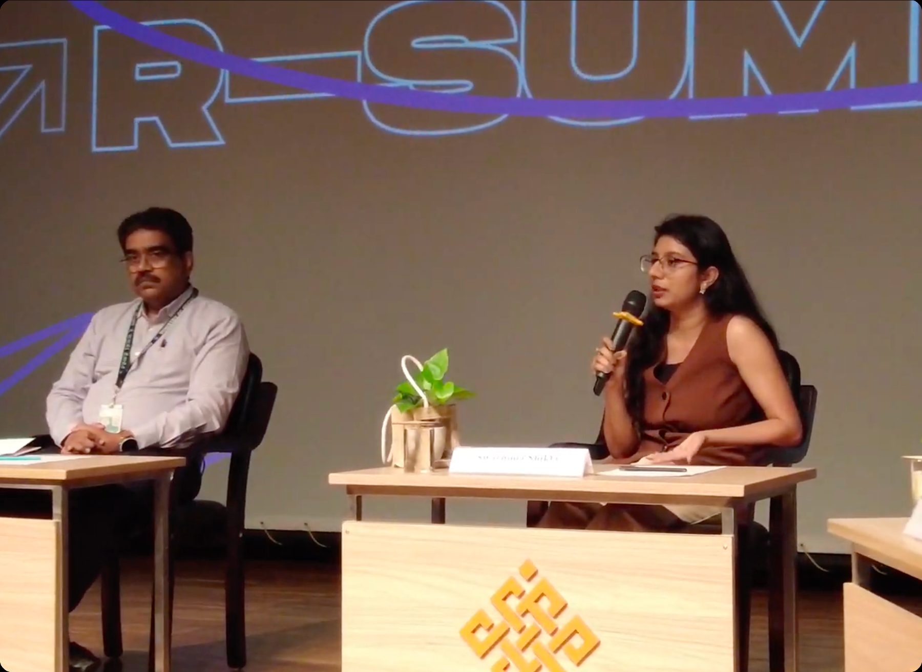 Speaking on a panel at a summit.