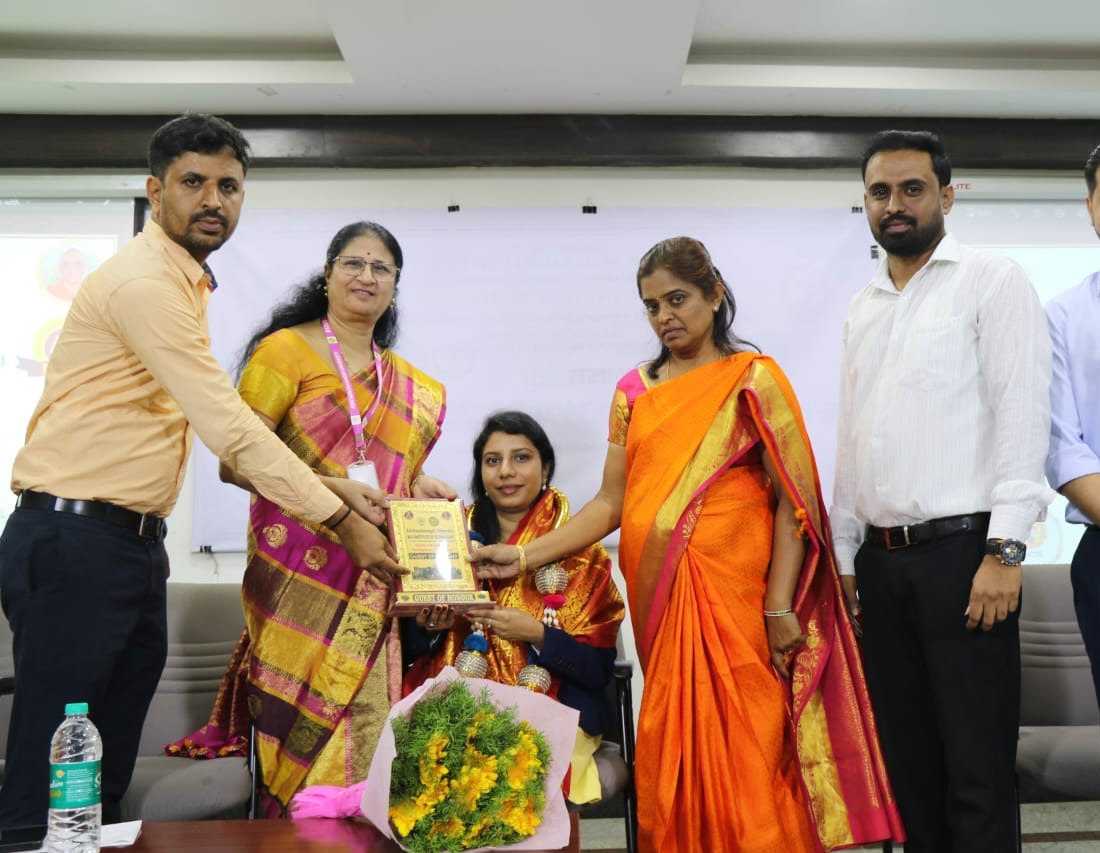 Receiving a guest of honour memento after a session at an institute.
