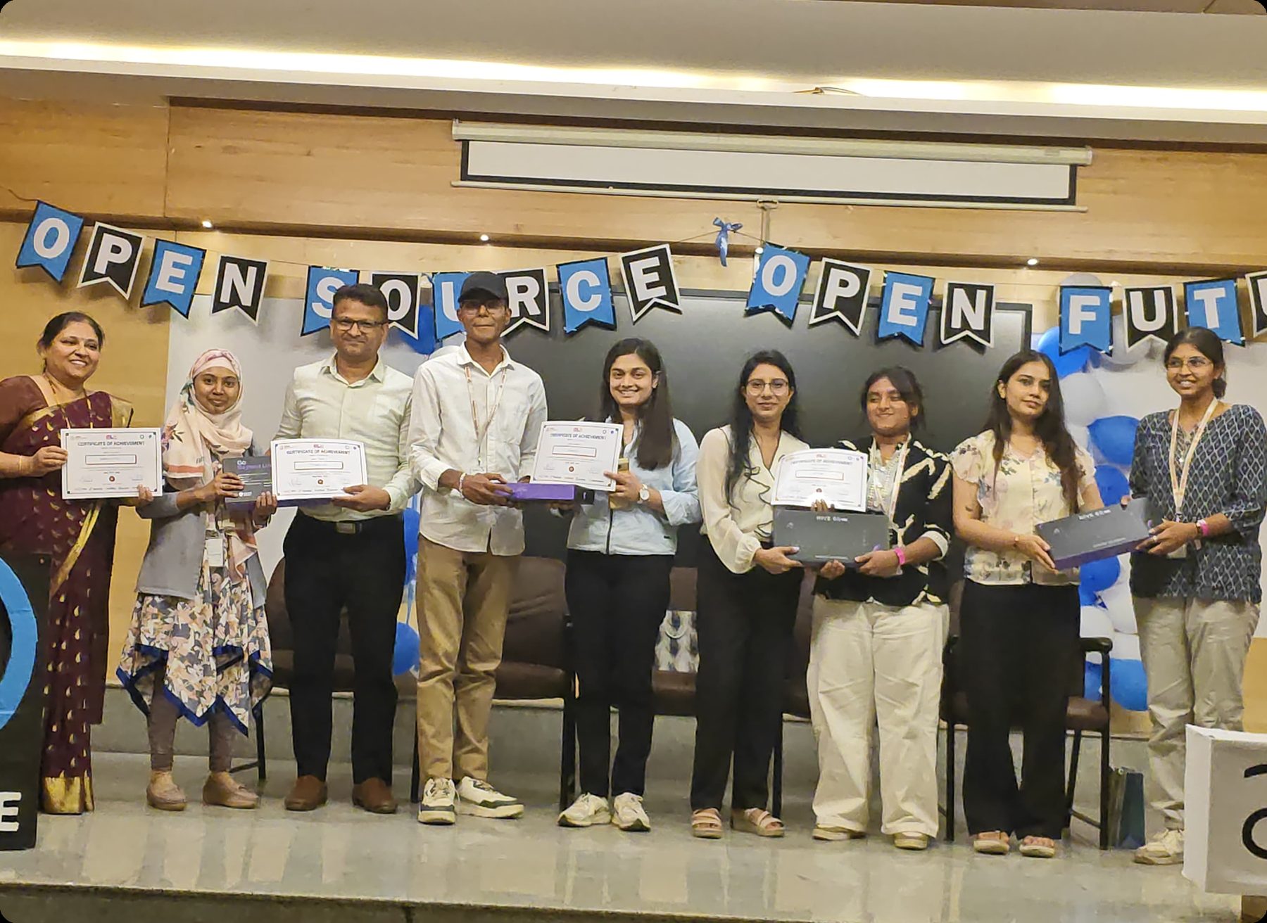 Certificate presentation at an open source event.
